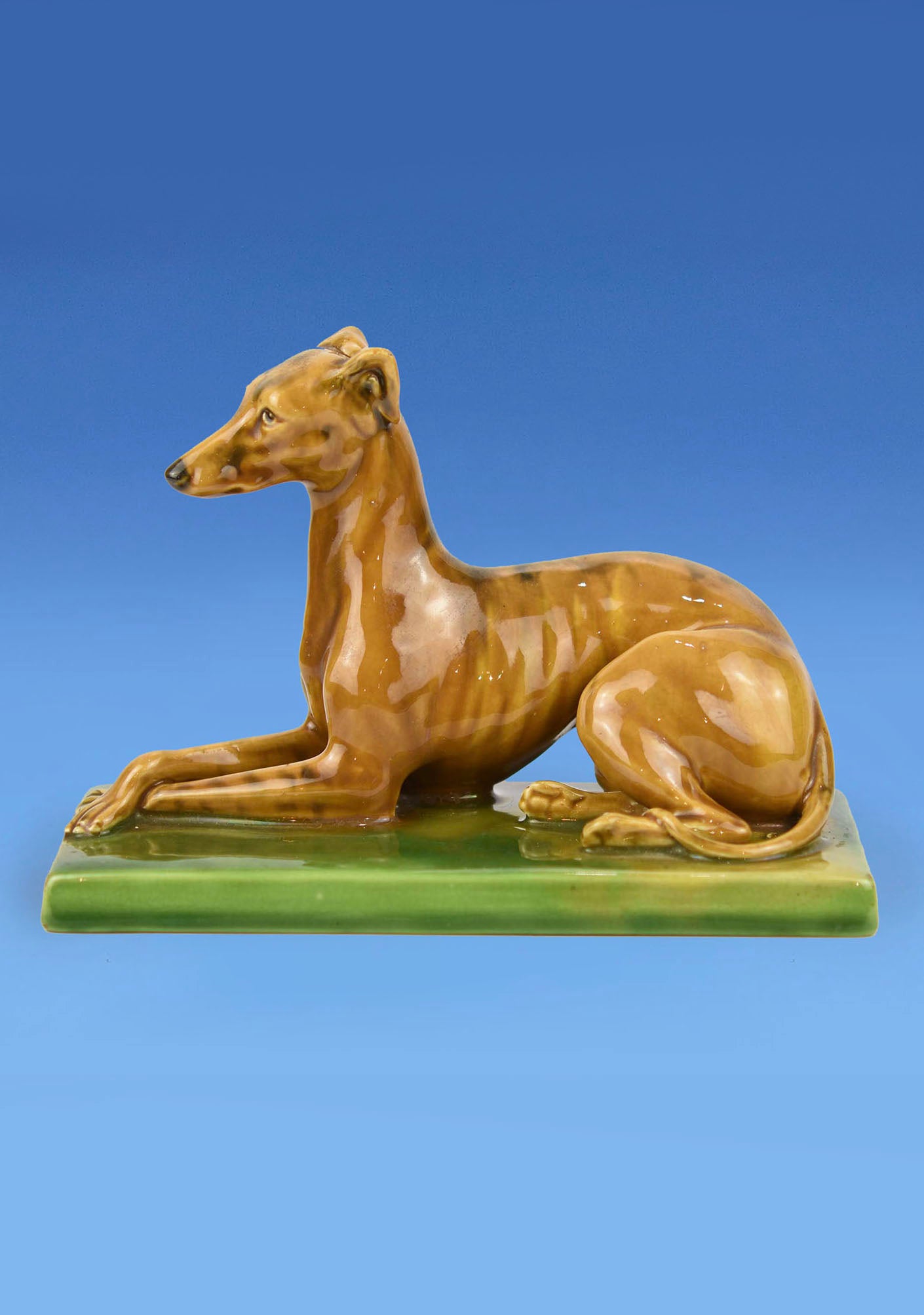 Minton Majolica Paperweight c.1890 in the form of a Recumbent Greyhound sculpted by Paul Comolera